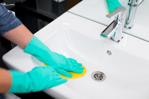Final safety-focused oven cleaning step with protective clothing