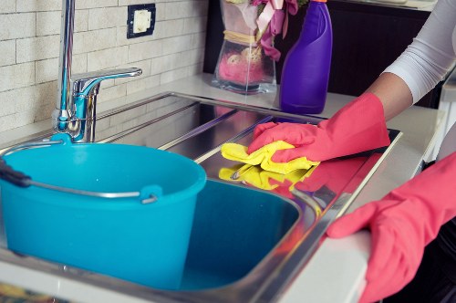 Professional domestic cleaner working in a kitchen in Ealing